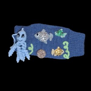 Exterior Features of the muff: Crocheted Fishes, Crocheted Spiral Plants, Stone made from croched covered juice bottle cap and a crocheted octopus